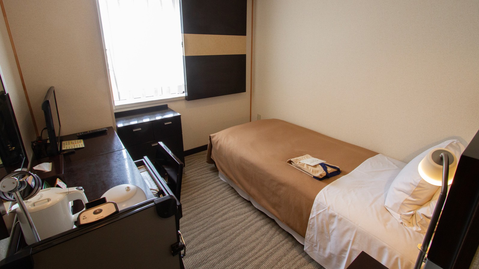 シングルルーム／1泊から短期の滞在に！枕は2種類完備、コンパクトな客室です。（客室一例）