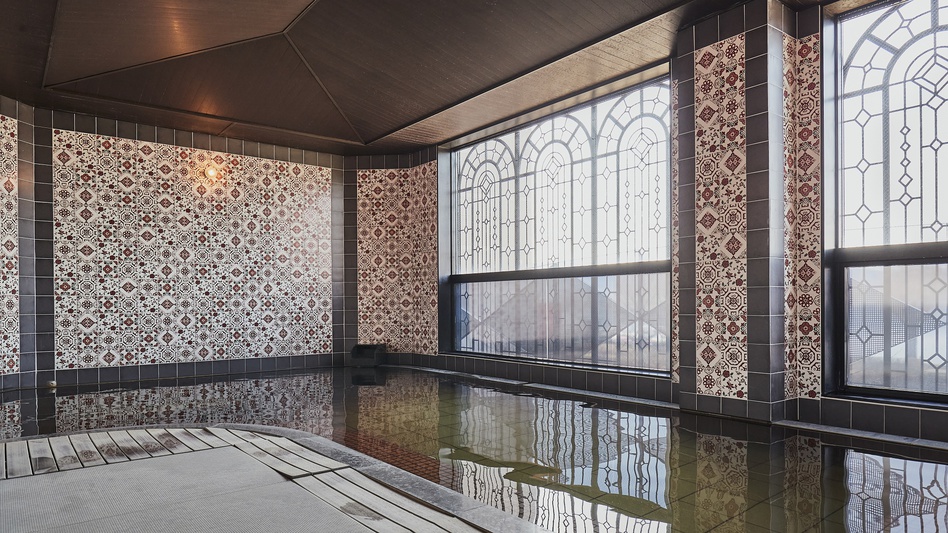 【女性大浴場】総タイル張り、窓にはアイアンフレームを施したアールデコスタイルの大浴場