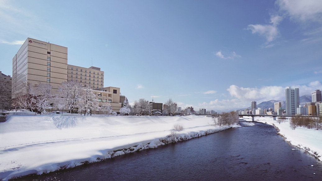 【外観】雪に包まれた豊平川に面したホテル外観