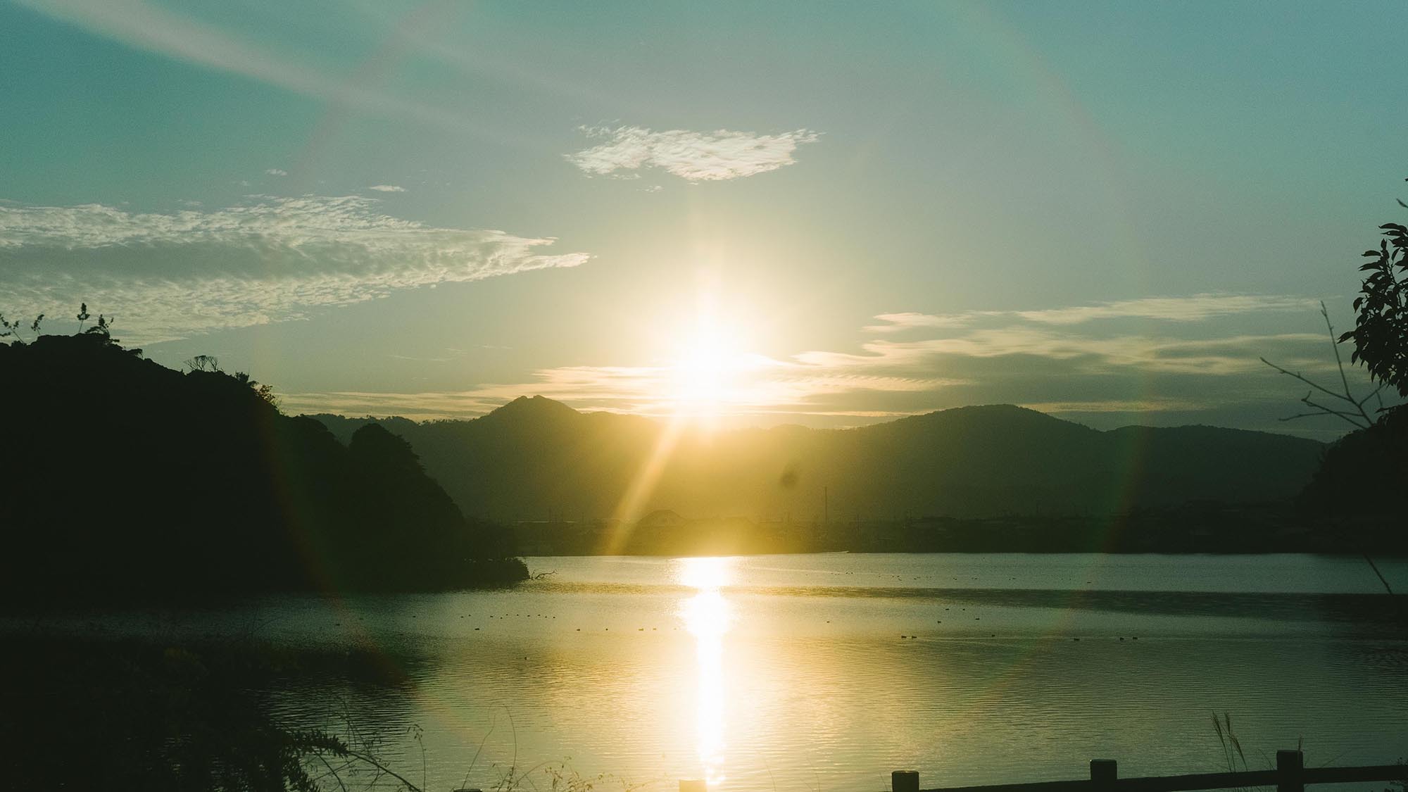 夕日が湖面にきらめくレイクビュー。開放的な水辺の風景。