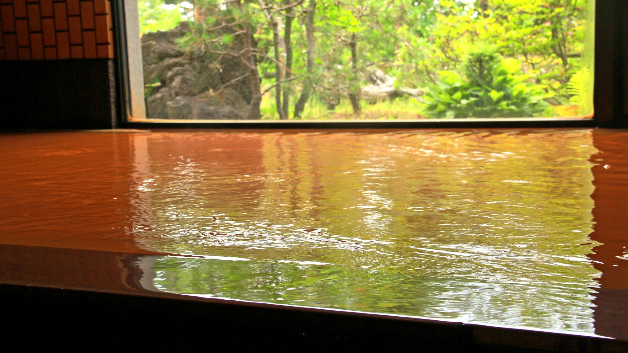 １階にある、木々に囲まれた秘湯風呂「岳」四季折々、絵画のような美しい景色をお楽しみください。