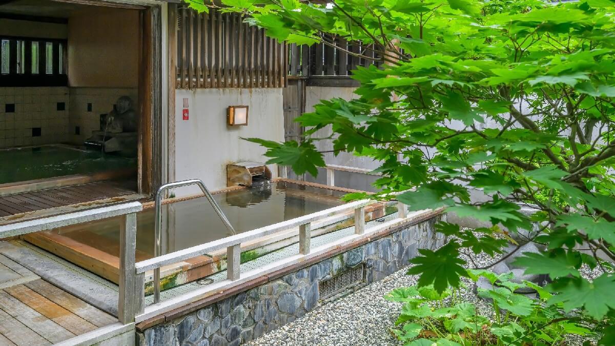 【月岡湯香炉】京風庭園を望む露天風呂。お湯かけ小僧「米吉」がそっと見守ります。