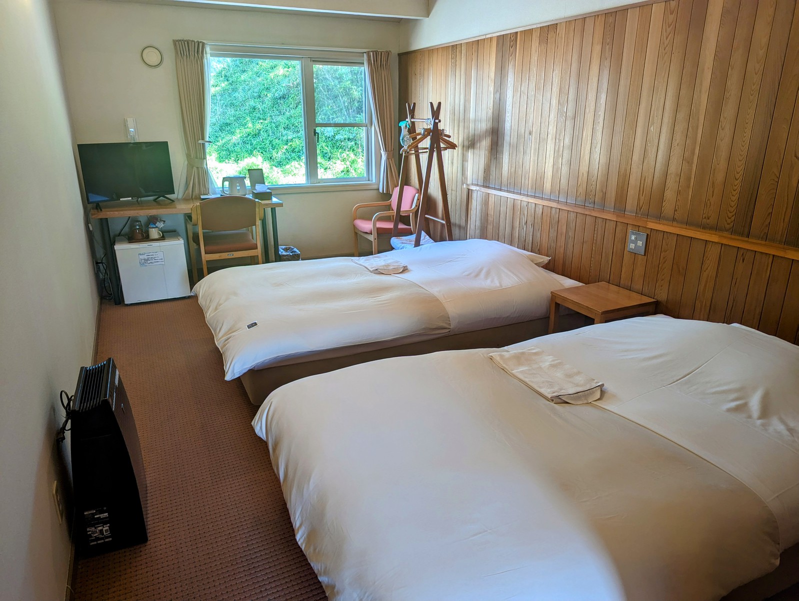 天井の高い部屋にレッドシダーが張っております。窓から森が見えます。セミダブルベットが２台あります。