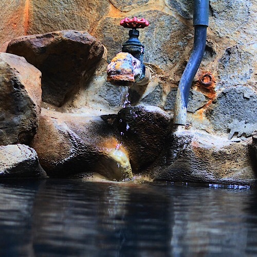 天然温泉掛け流しの露天風呂。岩風呂と暖色の照明がおりなす雰囲気をお楽しみ下さい。