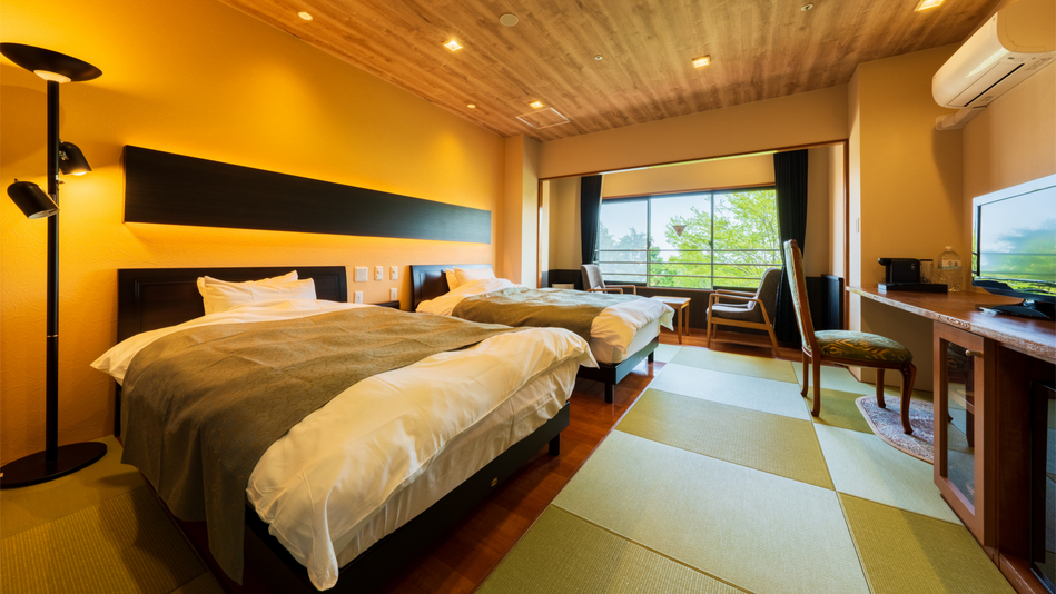 【デラックスツイン】ビジネス利用にも便利なデスク・Wi-Fi完備。（客室一例）