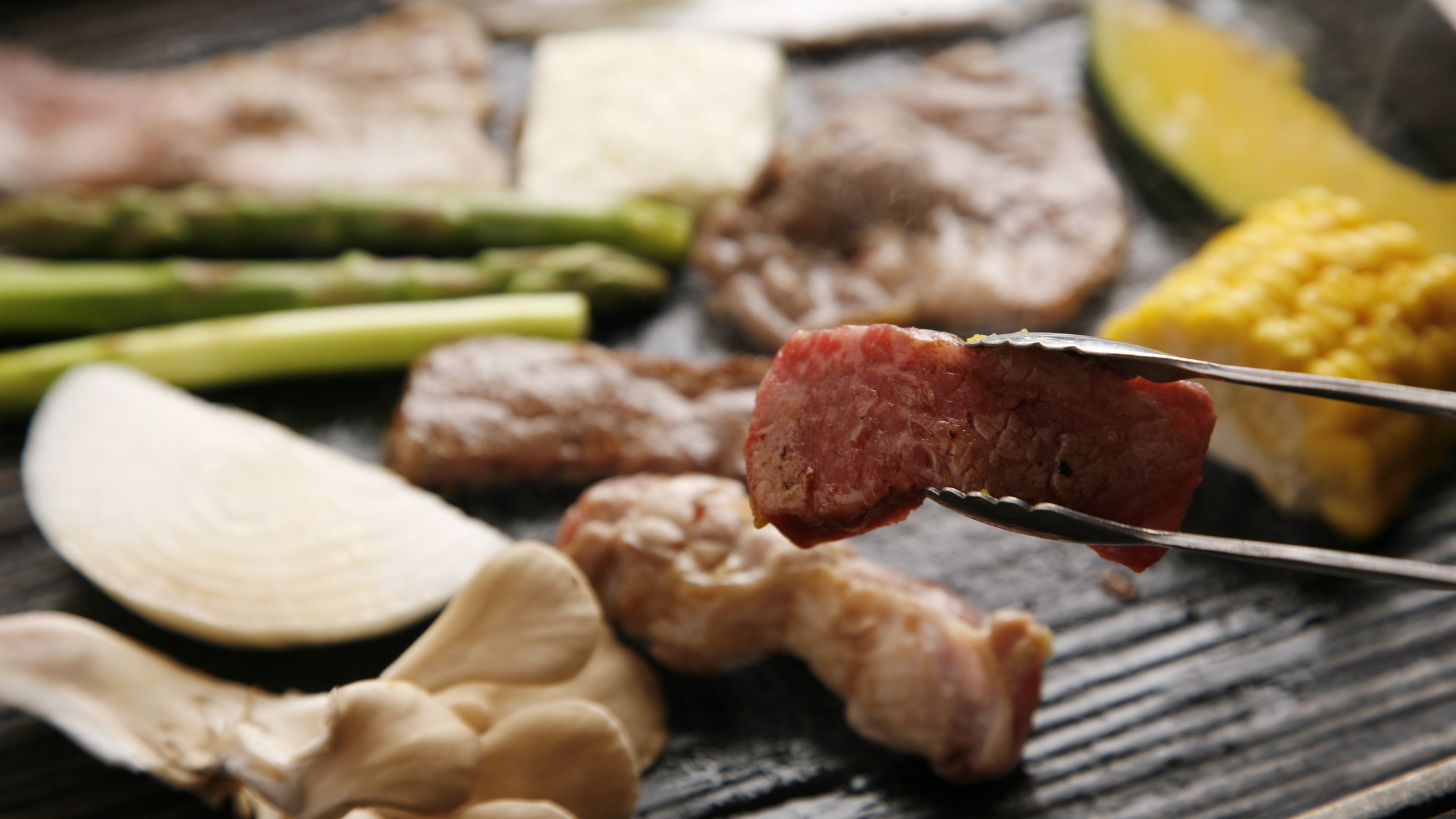 ヌプリ目の前の鉄板で好みの焼き具合で北海道の食材を焼いてください。