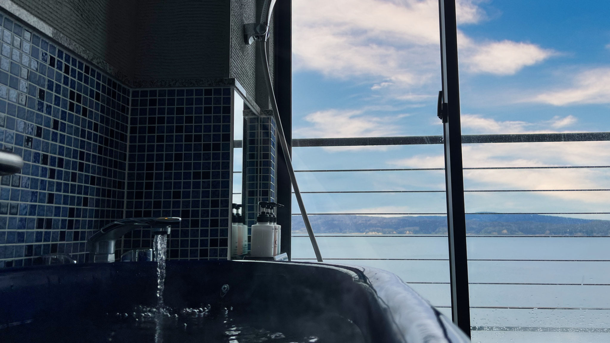 展望風呂付和室10畳海側に大きな窓のお風呂と掘り炬燵の間